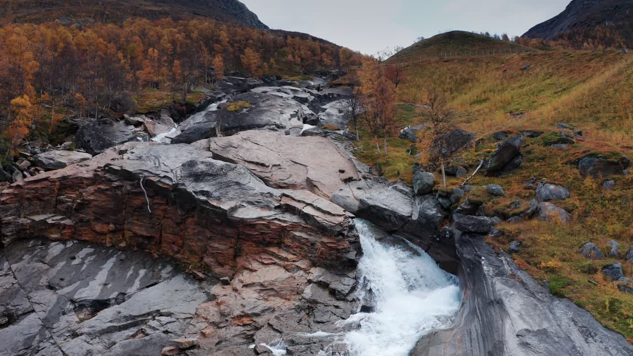 una vista aérea del río salvaje corre en el estrecho cauce rocoso a través del paisaje otoñal