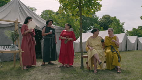 women in roman-era costumes at a historical re-enactment