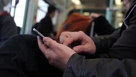 man hands texting on smartphone on garden close up hands