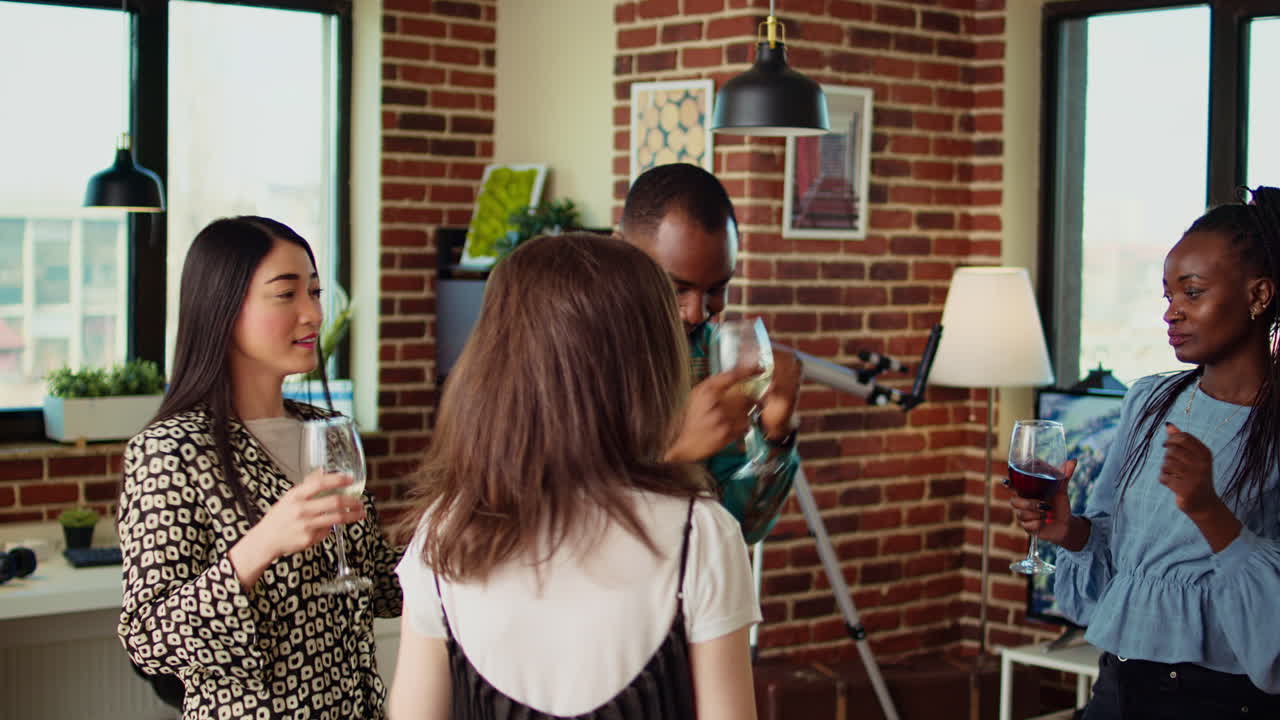 Multiracial school colleagues organizing apartment party, enthusiastically dancing to electronic music