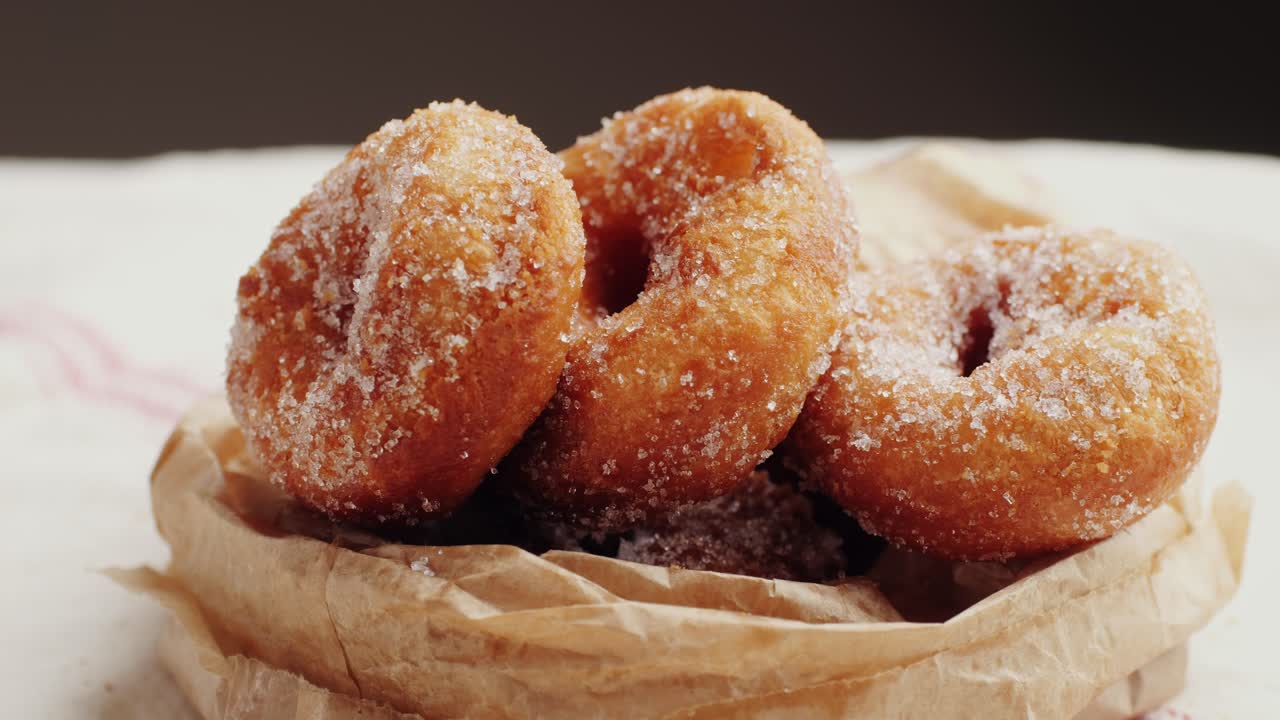 Sugar-dusted Donuts in Brown Paper