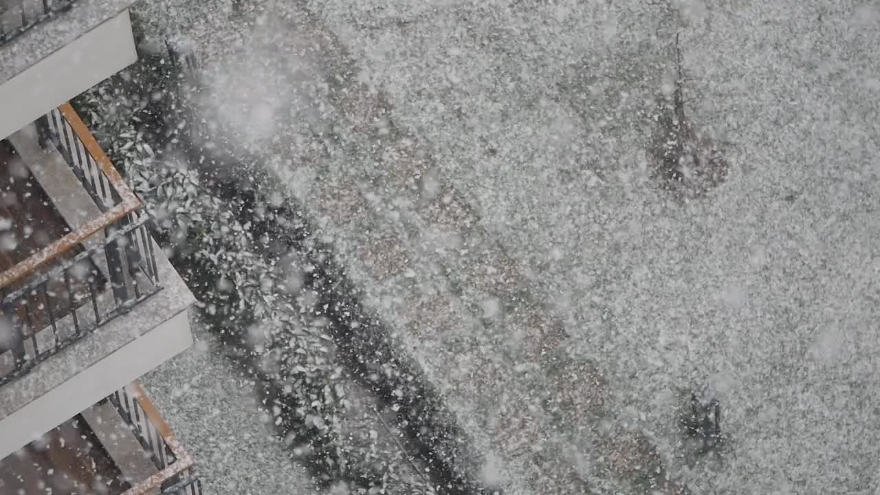 Snowy street scene near a building