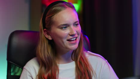 smiling young woman in a white shirt sitting in a chair