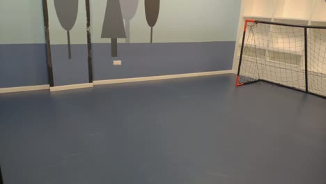 small children's soccer field with goals inside the leisure park with decorated walls for children and birthday celebrations, shooting turning left, ordes, galicia, spain