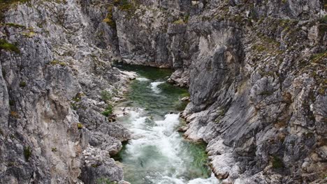 rapid mountain river flowing through deep canyon