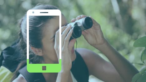 animation of smartphone icon over caucasian woman using binoculars