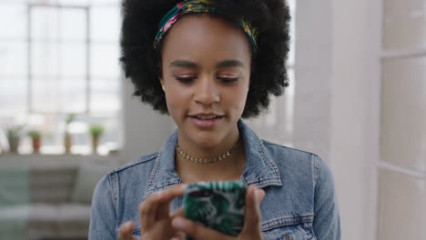 portrait of cute trendy black woman smiling enjoying texting browsing social media using smartphone mobile technology wearing stylish denim jacket