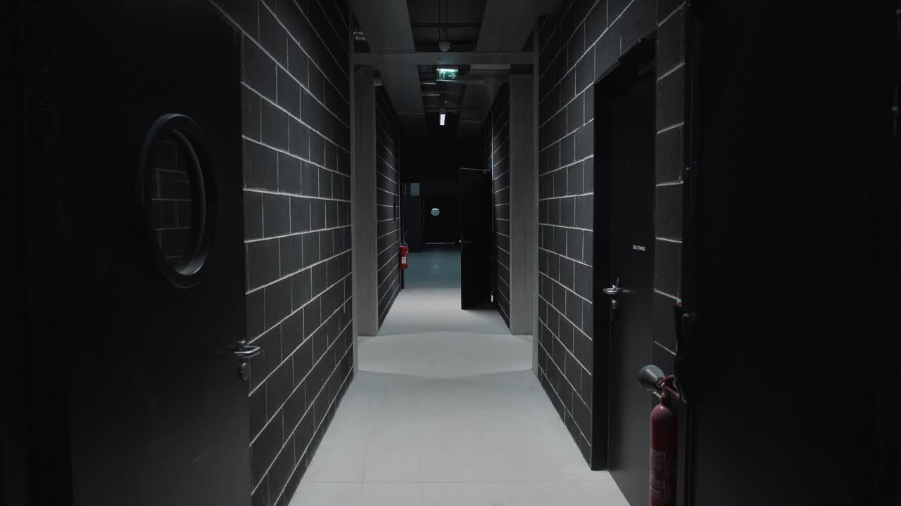 dolly shot through a building hallway decorated with black and grey tiles