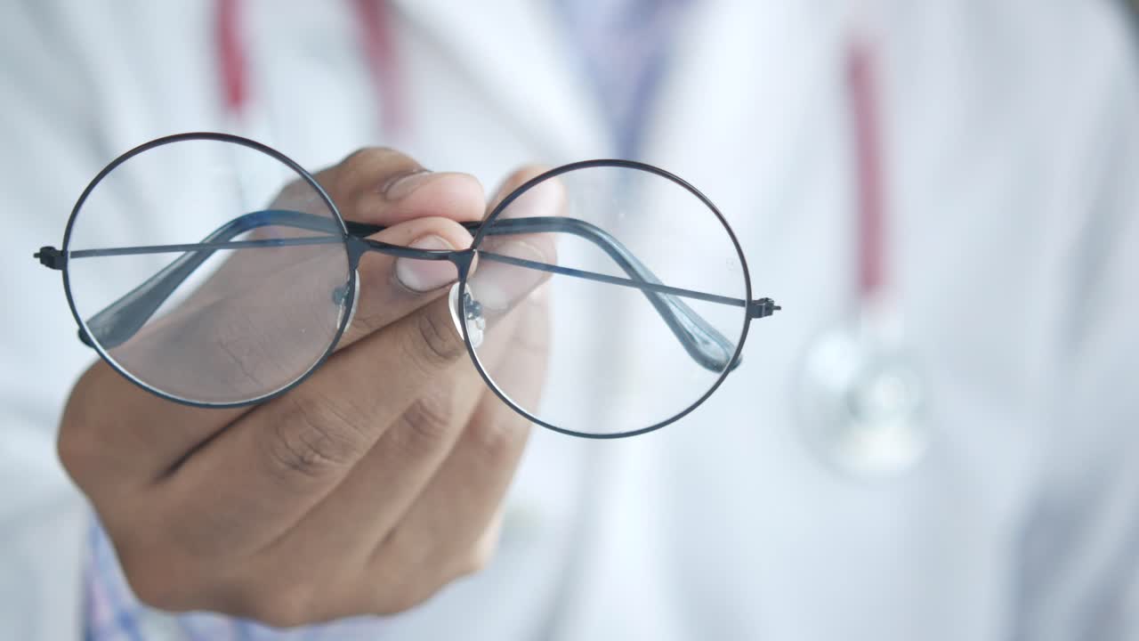 Doctor Holding Glasses