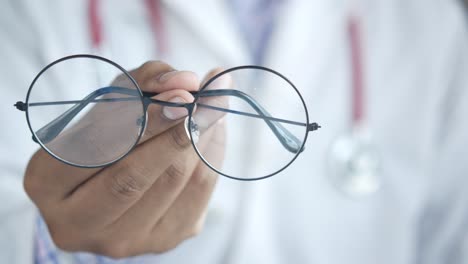 doctor holding glasses