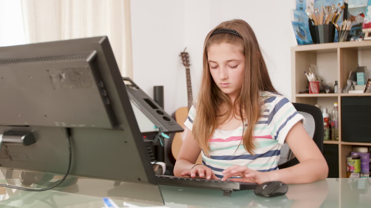 Girl using computer at desk