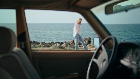 relaxed girl speaking smartphone walking on sunny ocean shore. woman calling