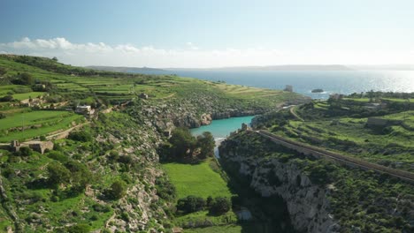 aerial: birds flying in canyon near magrr ix-xini bay on sunny day in winter