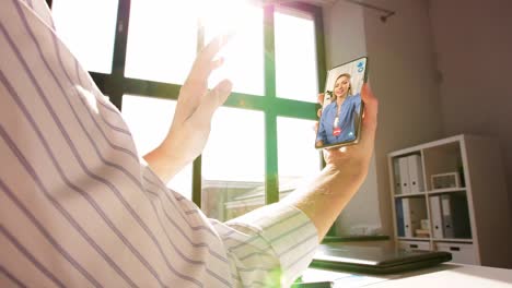 remote-job,-technology-and-people-concept--hand-of-woman-holding-smartphone-and-having-video-call-with-colleague-at-home-office