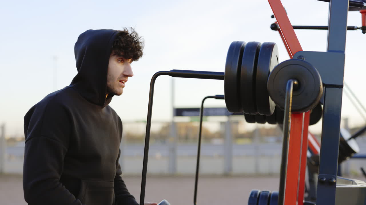 Man Working Out Outdoors on Gym Equipment