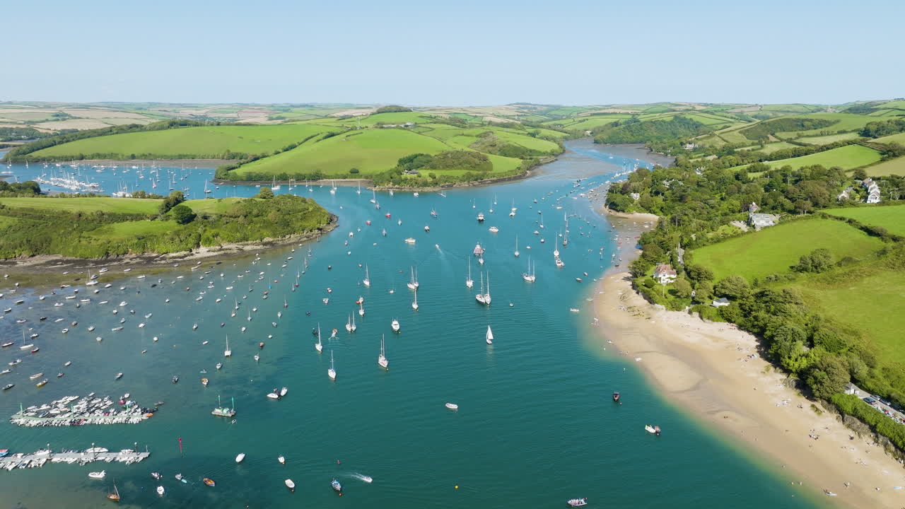 Aerial view of a beautiful coastal bay with boats and green hills