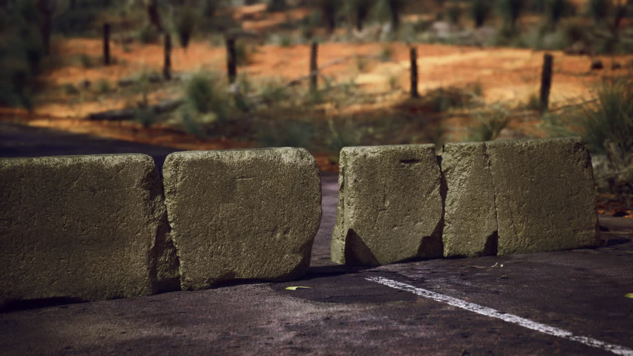 Traffic barrier blocks placed on a deserted road in a remote location