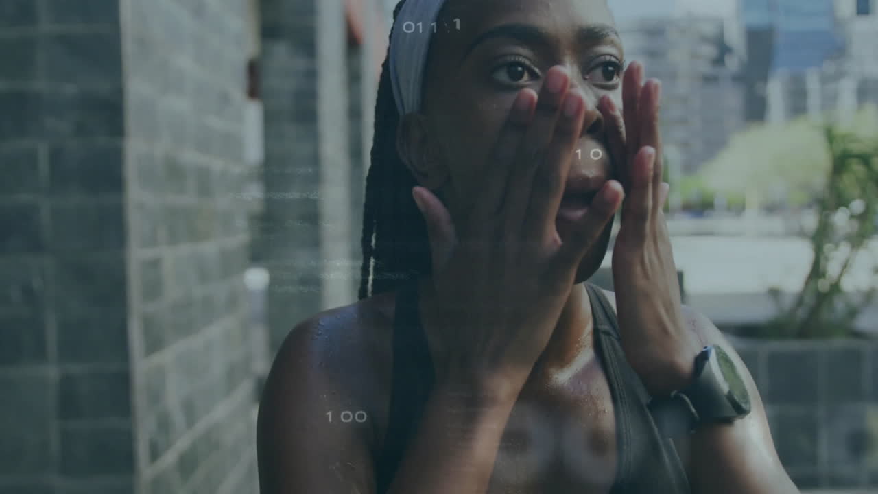 Wiping face, woman in athletic wear with animation of digital data overlay