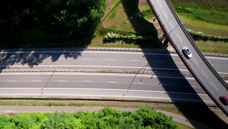 Aerial-view-of-vehicles-running-on-national-highway-and-overpass-on-bright-sunny-day