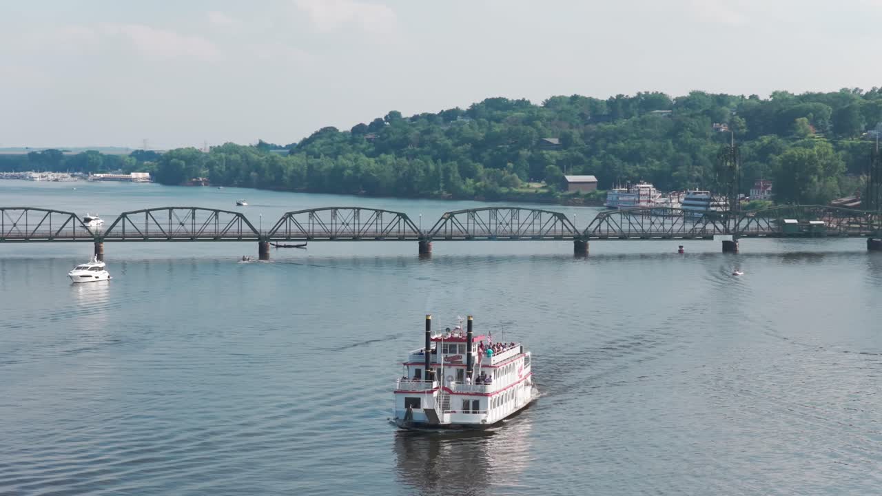 Telephoto panning close-up aerial shot of a riverboat near the St. Croix River lift bridge in Stillwater, Minnesota. 4K
