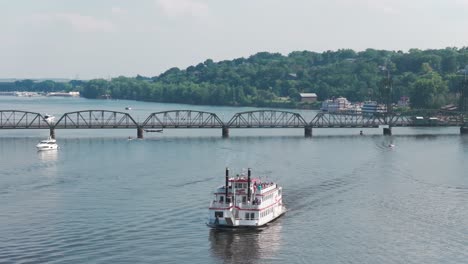 telephoto panning close-up aerial shot of a riverboat near the st. croix river lift bridge in stillwater, minnesota. 4k