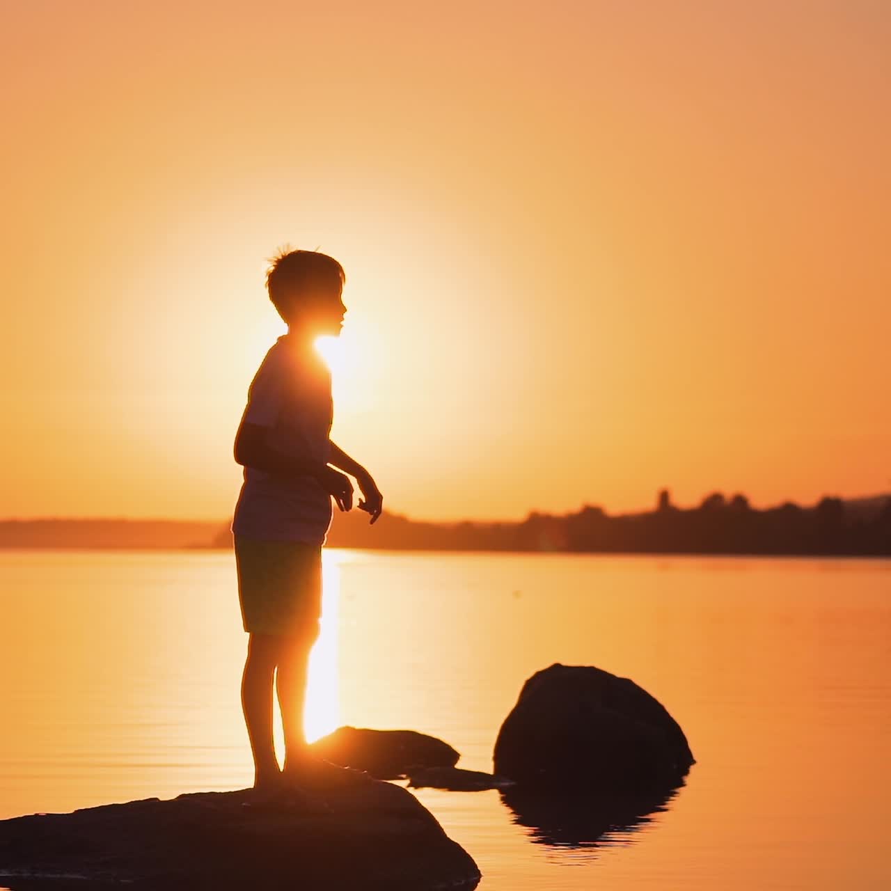 A happy child is playing with a paper airplane at sunset. Classes with children outdoors. Lifestyle