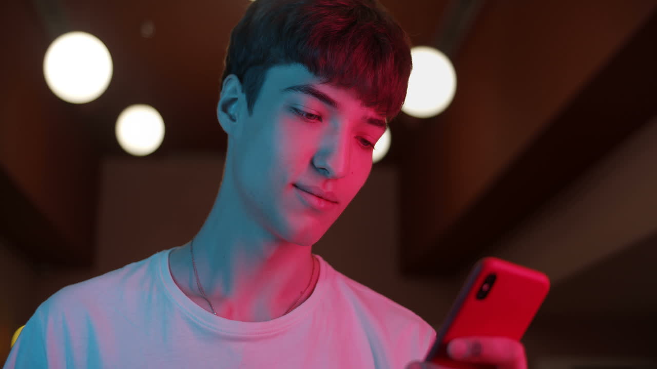 A man using a smartphone indoors