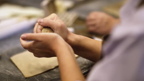 hands shaping clay