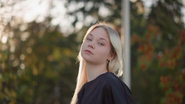 Retrato de una mujer joven rubia al aire libre al atardecer