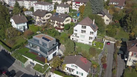 drone push out: lausanne, residential neighborhood in the town, trees and houses, urban environment, switzerland, vaud, aerial view