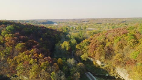 reverse-dolly flyover of autumn trees and hills at ledges state park