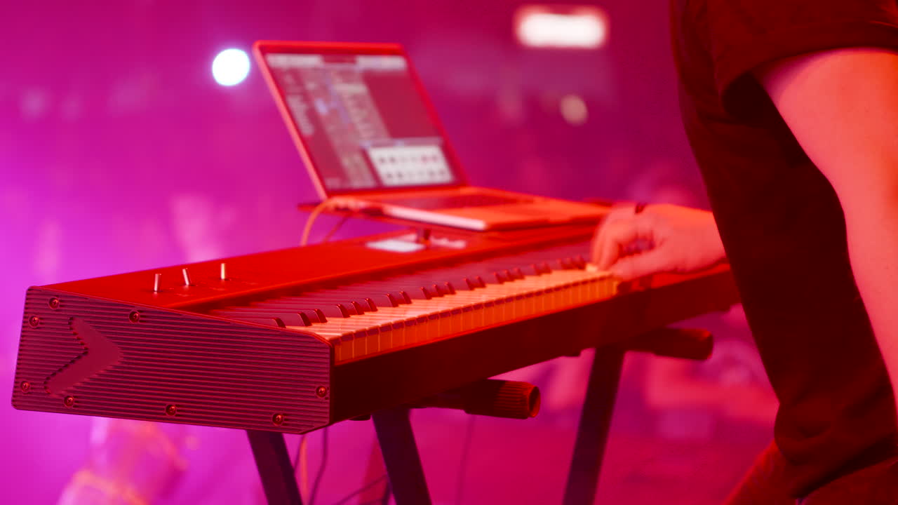 Keyboard player on stage with laptop