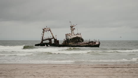 rusty shipwreck on a sandy beach