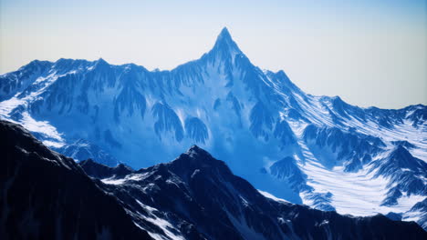 majestic snow covered mountain peak towering above surrounding ranges