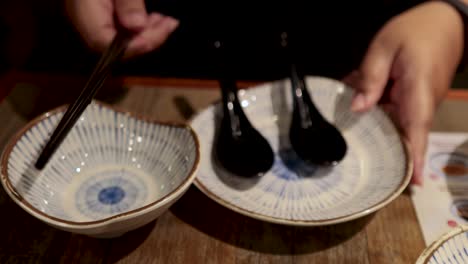 steamed buns served with chopsticks and plates