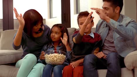 Smiling-Hispanic-family-put-their-hands-up-and-did-a-high-five