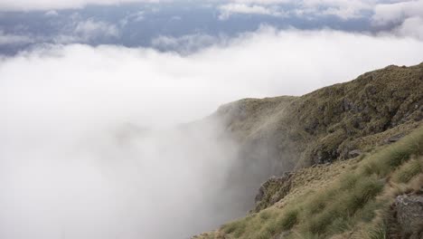 time-lapse of clouds crashing against the slopes of the mountain on a windy day