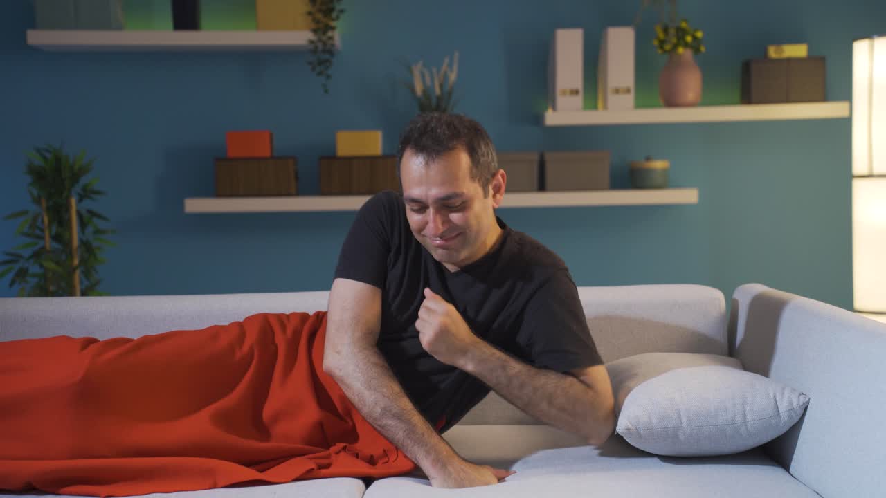 침대에서 카메라를 보며 웃는 남자.