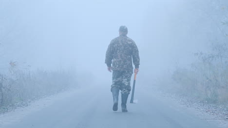 a murderer with a bloody ax on a forest road stands in the light of car headlights creepy crime scen