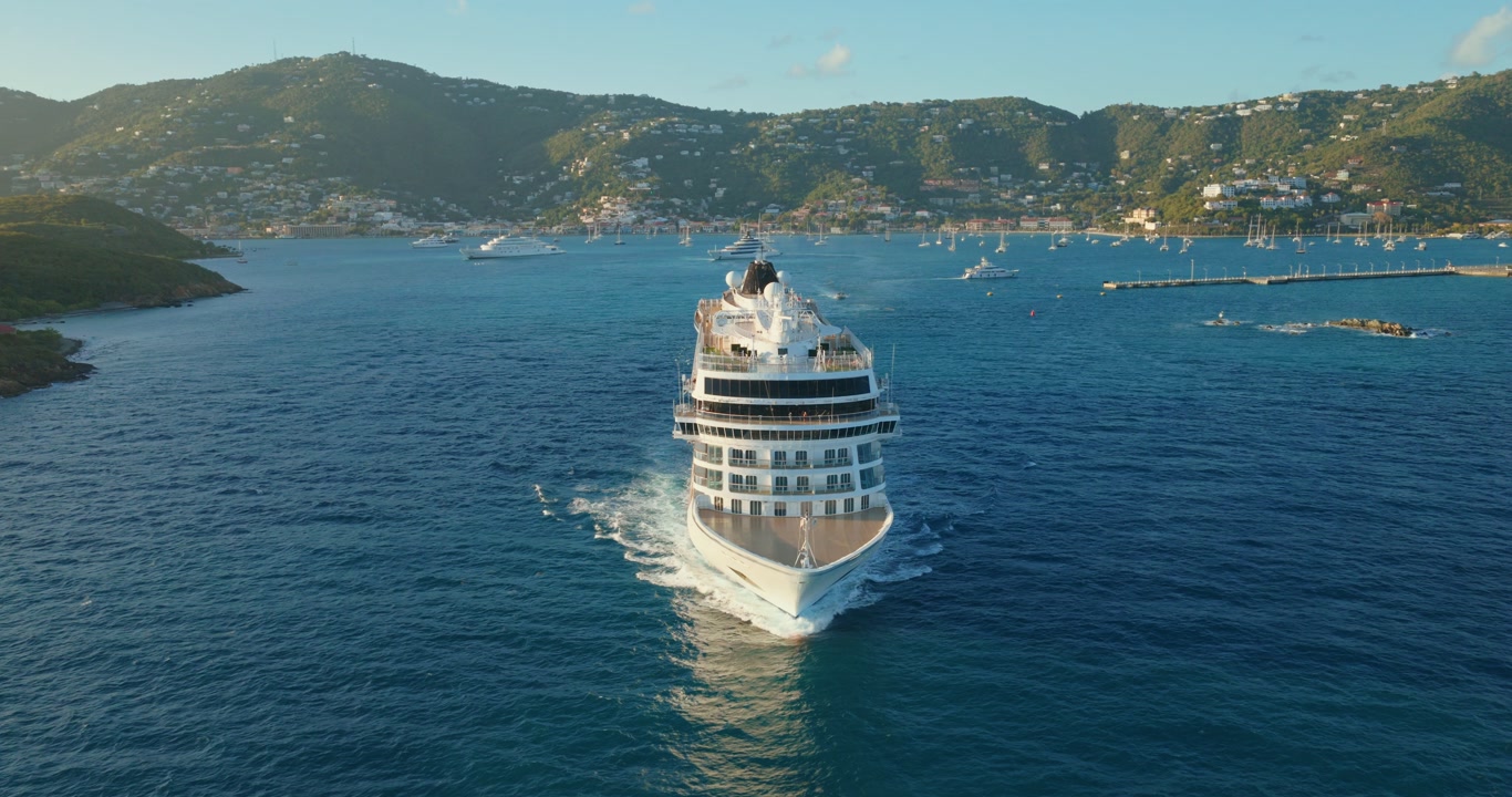 Luxury Cruise Ship Leaving Charlotte Amalie Harbor On The Island Of St. Thomas In The U.S. Virgin Islands. Aerial Pullback Shot