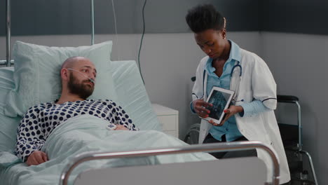 afro american practitioner doctor analyzing bones radiography