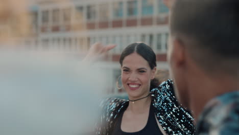 dancing woman on rooftop having fun dance party with friends at sunset enjoying crazy celebration