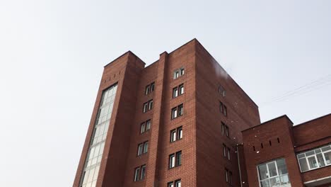 Snow-Flying-Off-Roof-Of-Apartment-Building-In-Ulan-Ude,-Russia