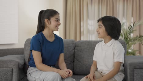 happy indian siblings talking to each other