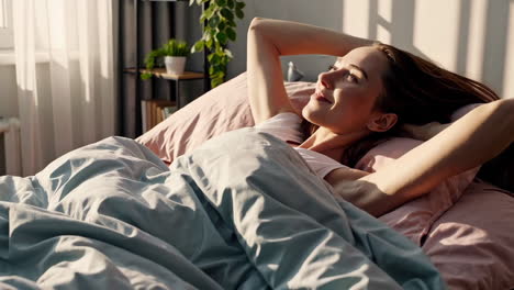 woman waking up in bed in the morning