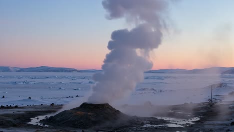 majestic geyser erupting in chilly twilight: captivating scene of nature's power and beauty amidst a snowy landscape