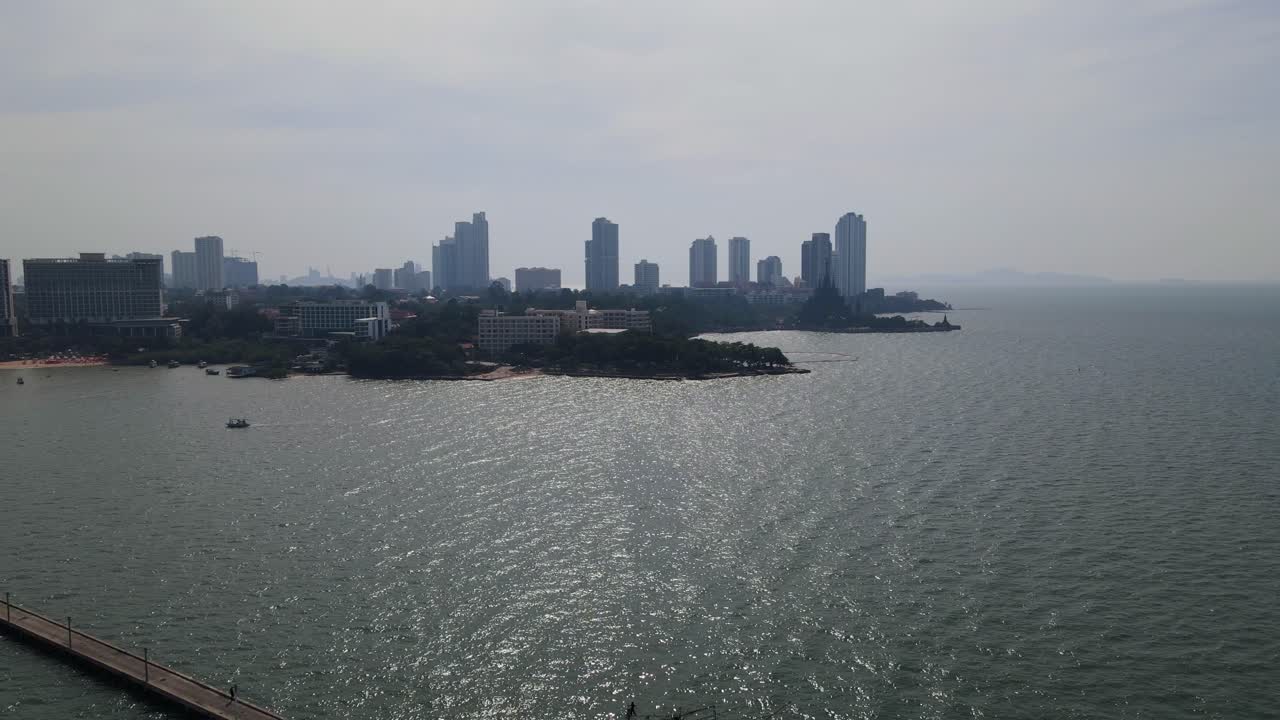 Aerial footage of the Pattaya Fishing Dock towards the Sanctuary of Truth with buildings and beachfronts, Pattaya, Chonburi, Thailand