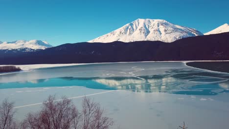 4K-Drone-Video-of-Snow-Covered-Lakeside-Mountains-in-Alaska-During-Winter