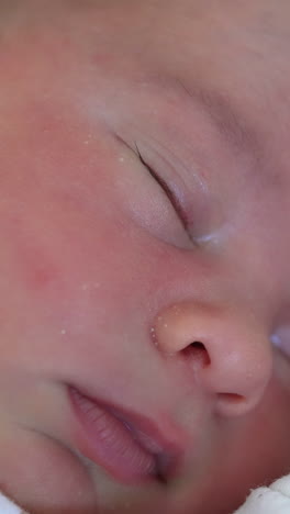 adorable infant sleeps. facial portrait of a cute newborn baby sleeping. healthy children's sleep. infant baby. close-up.. vertical video