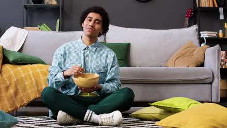 man eating chips in a bowl